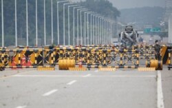 FILE - A soldier stands guard at a checkpoint on the Grand Unification Bridge which leads to the inter-Korean Kaesong Industrial Complex in North Korea, just south of the demilitarized zone separating the two Koreas, in Paju, South Korea, June 17, 2020.