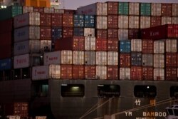 FILE - The YM Bamboo, a container ship operated by the China Ocean Shipping Company, is docked at the Port of Oakland in Oakland, Calif., Jan. 14, 2011.