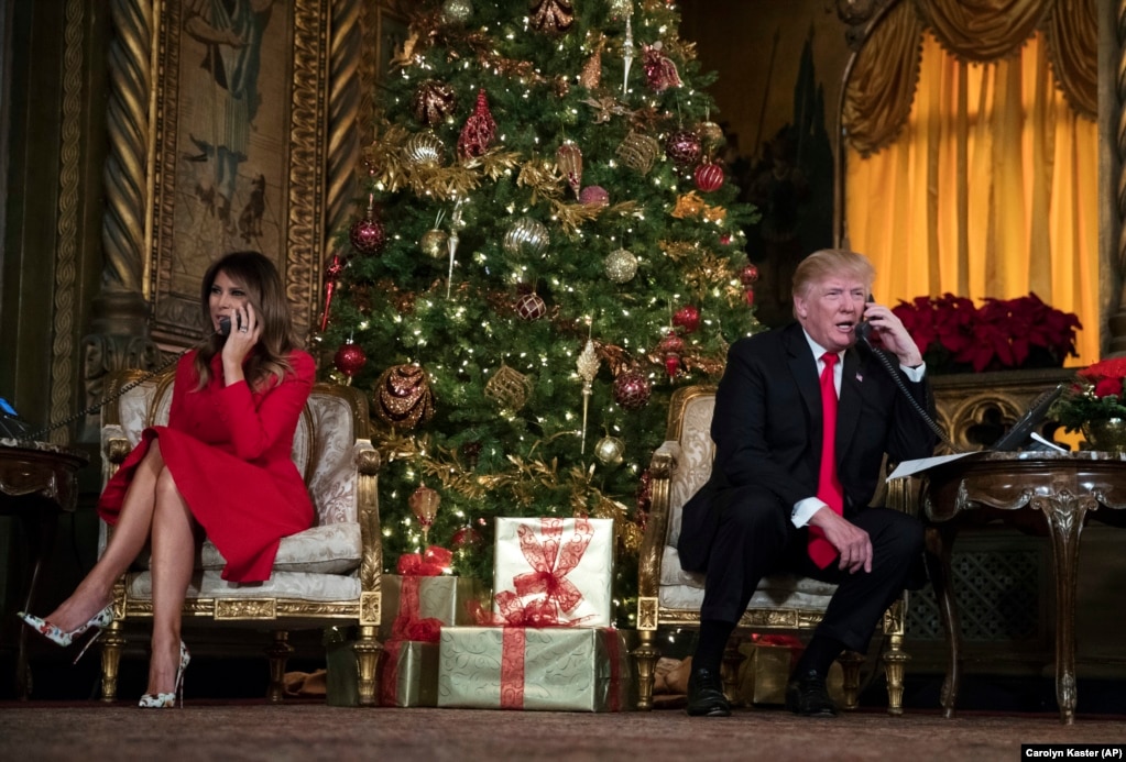 President Donald Trump and first lady Melania Trump speak on the phone with children as they track Santa Claus' movements with the North American Aerospace Defense Command (NORAD) Santa Tracker on Christmas Eve at the president's Mar-a-Lago estate in Palm Beach, Florida, Dec. 24, 2017.