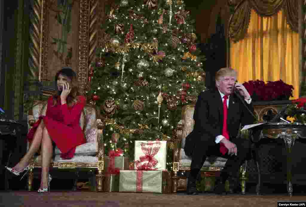 President Donald Trump and first lady Melania Trump speak on the phone with children as they track Santa Claus&#39; movements with the North American Aerospace Defense Command (NORAD) Santa Tracker on Christmas Eve at the president&#39;s Mar-a-Lago estate in Palm Beach, Florida, Dec. 24, 2017.