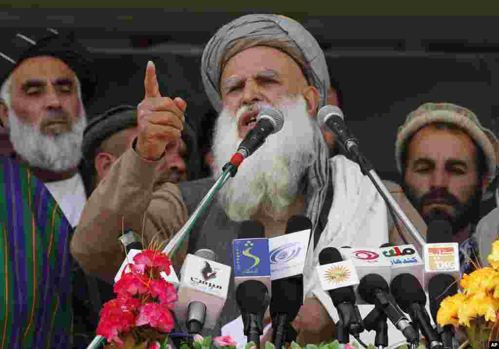 Presidential candidate Abdul Rasoul Sayyaf gestures as he talks to supporters at an election campaign rally in Kandahar, March 31, 2014.