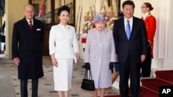 From left, the Duke of Edinburgh, China's first lady, Peng Liyuan, Queen Elizabeth II and the Chinese President Xi Jinping at the Grand Entrance to Buckingham Palace, London.