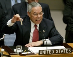 FILE - U.S. Secretary of State Colin Powell holds up a vial that he described as one that could contain anthrax, during his presentation on [Iraq] to the U.N. Security Council, in New York, Feb. 5, 2003.