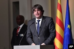 Ousted Catalan leader Carles Puigdemont addresses Catalan mayors who traveled to Brussels to take part in an event in support of the ousted Catalan government in Brussels, Belgium, Nov. 7, 2017.