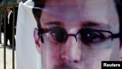 A banner supporting Edward Snowden, a former contractor at the National Security Agency (NSA), is displayed at Hong Kong's financial Central district on June 21, 2013