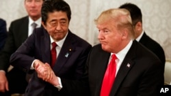 President Donald Trump, right, and Japanese Prime Minister Shinzo Abe shake hands during a meeting with Japanese families of those abducted by North Korea, at Akasaka Palace, Monday, May 27, 2019, in Tokyo.