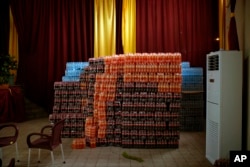 FILE - Crates of soft drinks are stored next to a stage prepared for a victory party for Presidential candidate Emmanuel Ramazani Shadary in the event of his winning the presidential elections in Kinshasa, Congo, Jan. 4, 2019.