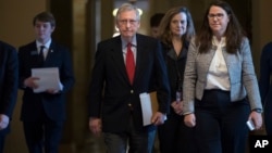 Senate Majority Leader Mitch McConnell, R-Ky., walks to the chamber on the first morning of a government shutdown after a divided Senate rejected a funding measure last night, at the Capitol in Washington, Jan. 20, 2018.