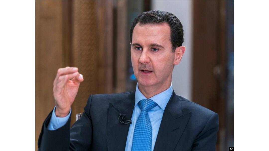 FILE - In this photo released June 13, 2018, by the Syrian official news agency SANA, Syrian President Bashar al-Assad speaks during an interview with Iran's Al Alam TV, in Damascus, Syria.
