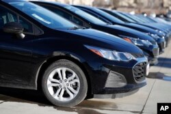 A long row of unsold 2019 Cruze sedans sits at a Chevrolet dealership in Littleton, Colo., Feb. 3, 2019.