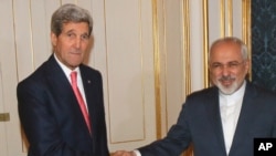 U.S. Secretary of State John Kerry shakes hands with Iranian Foreign Minister Mohammad Javad Zarif, right, prior to a bilateral meeting of the closed-door nuclear talks with Iran in Vienna, Austria, Nov. 23, 2014.