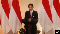FILE - Japanese Foreign Minister Fumio Kishida delivers a speech during the second Conference on Cooperation among East Asian Countries for Palestinian Development in Jakarta, Indonesia, March 2014.