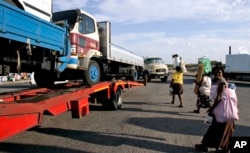 FILE - Trucks laden with goods headed for Zimbabwe are seen near the Beitbride border post between South Africa and Zimbabwe, in Musina, South Africa, March 28, 2008.