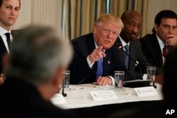 President Donald Trump speaks during a meeting with manufacturing executives at the White House in Washington, Feb. 23, 2017. From left are, White House Senior Adviser Jared Kushner, Trump, Merck CEO Kenneth Frazier, and Ford CEO Mark Fields.