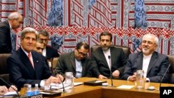 U.S. Secretary of State John Kerry, left, and Iranian Foreign Minister Mohammad Javad Zarif attend a meeting of the five permanent members of the Security Council plus Germany during the 68th session of the United Nations General Assembly at U.N. headquarters, Sept. 25, 2013.