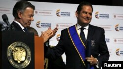 Colombia's President Juan Manuel Santos claps at an event where Colombia's Vice President German Vargas Lleras presented his office's annual report in Bogota, March 14, 2017. 