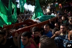 Palestinians carry the body of Mousab Abu Leila, during his funeral after the 29-year-old was killed during a protest on the border with Israel, in Gaza City, May 14, 2018.