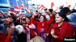 Supporters of Nepali Congress Party cheer as Constituent Assembly Election scores are displayed on a screen in Kathmandu, Nov. 21, 2013.
