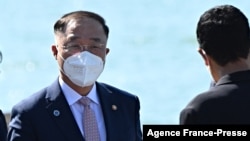 FILE - Minister of Economy and Finance of South Korea Hong Nam-ki (L) arrives for the G-20 finance ministers and central bankers meeting in Venice on July 9, 2021.