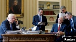 FILE - U.S. President Donald Trump (left to right), joined by Chief of Staff Reince Priebus, Vice President Mike Pence, senior advisor Steve Bannon, and Communications Director Sean Spicer, speaks by phone with Russia's President Vladimir Putin.