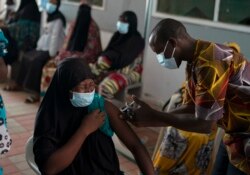 A health worker administers a dose of the Johnson & Johnson COVID-19 vaccine at the Bundung Maternal and Child Health Hospital in Serrekunda, outskirts of Banjul, Gambia, Sept. 23, 2021.