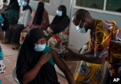 A health worker administers a dose of the Johnson & Johnson COVID-19 vaccine at the Bundung Maternal and Child Health Hospital in Serrekunda, outskirts of Banjul, Gambia, Sept. 23, 2021.