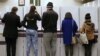 Voters fill in their ballots at a polling station at Town Hall in Sydney, Saturday, July 2, 2016. 