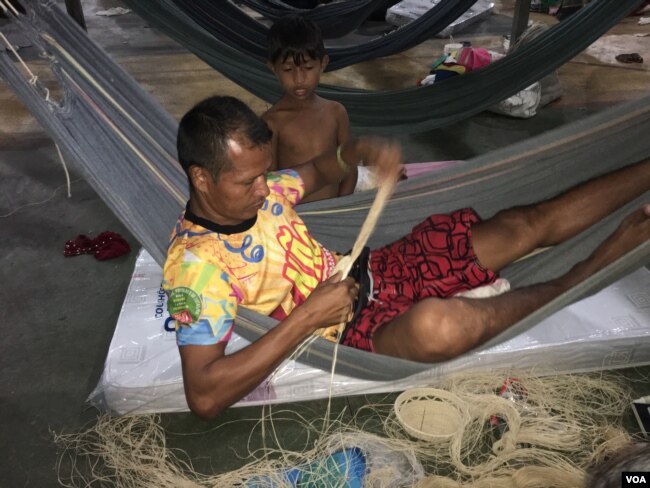 Baudillo Centeno, an indigenous Warao man, weaves at a refugee camp in Boa Vista, Brazil.