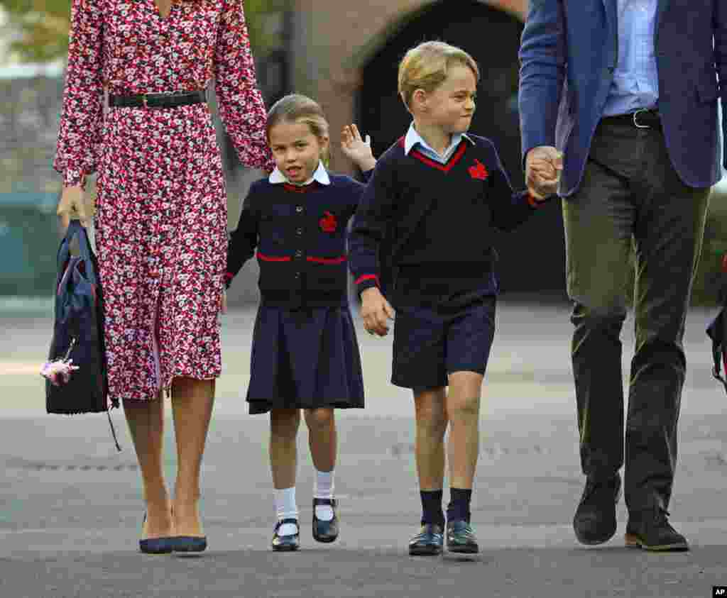 Britain&#39;s Princess Charlotte, left, with her brother Prince George and their parents Prince William and Kate, Duchess of Cambridge, arrives for her first day of school at Thomas&#39;s Battersea in London.