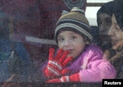 A child reacts from inside a bus evacuating people from a rebel-held sector of eastern Aleppo, Syria Dec. 15, 2016.