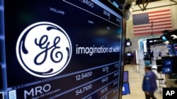 The General Electric logo appears above a trading post on the floor of the New York Stock Exchange, June 12, 2017. GE said Jeff Immelt is stepping down as CEO and John Flannery will take over the post in August. 