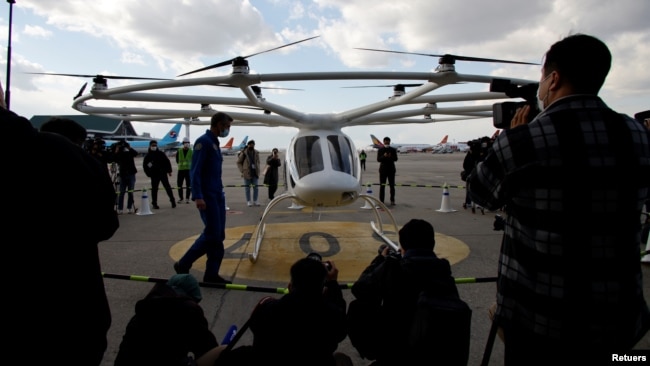 Reporters cover the "Volocopter 2X" drone taxi during an Urban Air Mobility Airport Demo event at Gimpo Airport in Seoul, South Korea, November 11, 2021. (REUTERS/Heo Ran)