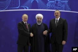 In this photo released by the office of the Iranian Presidency, Iranian President Hassan Rouhani, center, Russian President Vladimir Putin, left, and Azerbaijan's President Ilham Aliyev, right, shake hands after their trilateral meeting in Tehran, Iran, Nov. 1, 2017.
