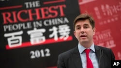 FILE - Rupert Hoogewerf delivers a speech at the Hurun report entrepreneurs summit at a hotel in Beijing, Oct. 19, 2012. The Hurun Report publishes an annual list of the richest people in China.