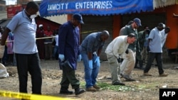 Forensic teams search for evidence at the scene of a bomb blast in the Somali district of Eastleigh, in Nairobi, April 1, 2014. 