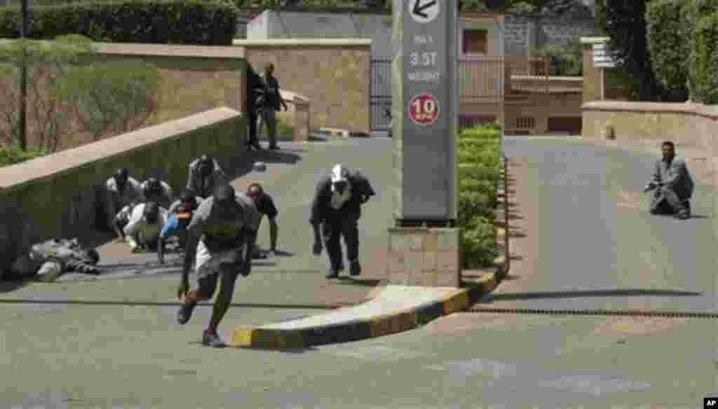 A body, left, lies outside the Westgate Shopping Mall, an upscale shopping center in Nairobi, Kenya Saturday Sept. 21 2013.