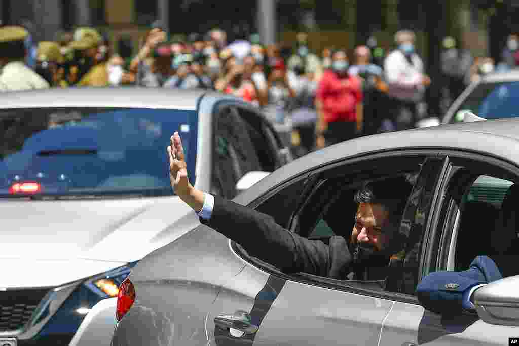 Chilean President-elect Gabriel Boric waves to supporters as he arrives to La Moneda presidential palace for a meeting with current President Sebastian Pinera in Santiago, Chile.
