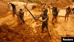 Artisanal miners dig for gold in an open-pit concession near Dunkwa, western Ghana, Feb. 15, 2011.