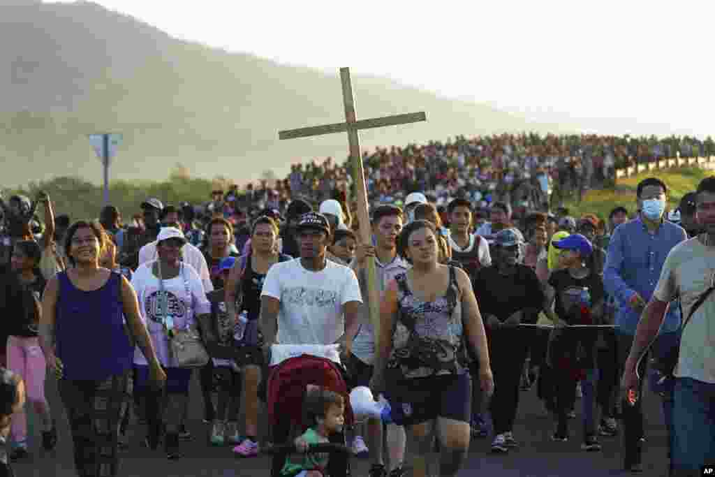 Migrants leave Huixtla, Chiapas state, Mexico, as they continue their trip north toward Mexico's northern states and the U.S. border.