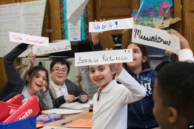 In this March 1, 2017, photo, students display some of their cursive writing work and exercises at P.S. 166 in the Queens borough of New York.