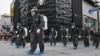 FILE - South Korean health officials from Bupyeong-gu Office wearing protective gear, spray disinfectants at a shopping district in Incheon on Sept. 17, 2020, amid the COVID-19 pandemic.