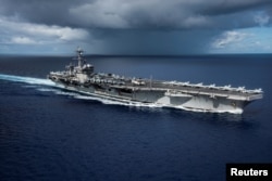 FILE - The Nimitz-class U.S. Navy aircraft carrier USS Carl Vinson transits the Philippine Sea, April 23, 2017.