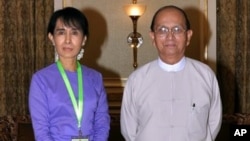 Myanmar's democracy icon Aung San Suu Kyi, left, and President Thein Sein pose for photos before their meeting at the presidential office on Friday, Aug. 19, 2011 in Naypyitaw, Myanmar's administrative capital. (AP Photo)