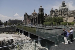 People observe the archaeological site of Templo Mayor in the historic center of Mexico City, Tuesday, May 18, 2021.(AP Photo/Eduardo Verdugo)