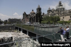 People observe the archaeological site of Templo Mayor in the historic center of Mexico City, Tuesday, May 18, 2021.(AP Photo/Eduardo Verdugo)