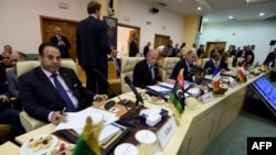 Interior minister of Libya's Government of Nationa Accord (GNA) Aref El-Khoja, left, and French Interior Minister Gerard Collomb, second left, take part in the opening meeting on security attended by interior ministers from central Mediterranean countries, July 24, 2-17.