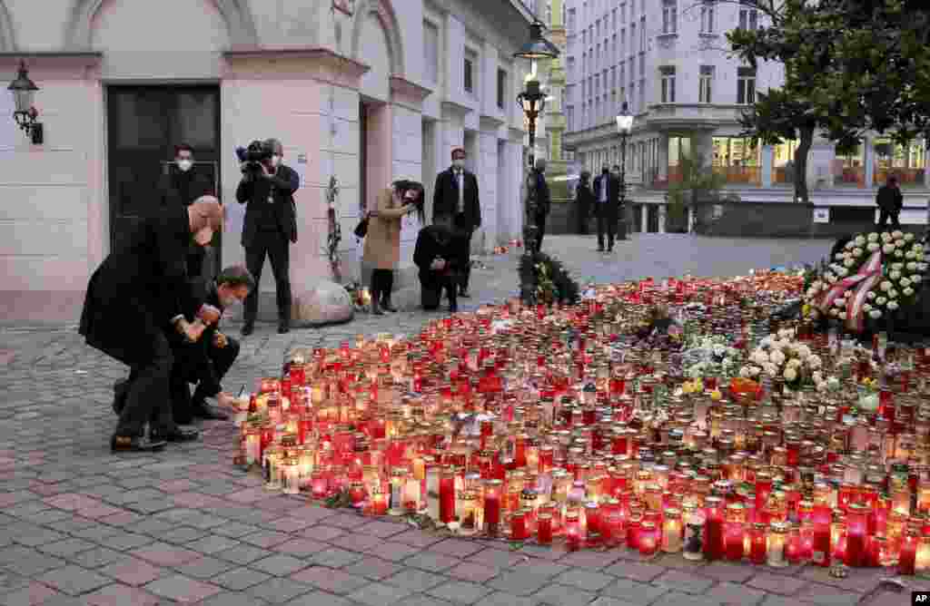 President of the European Council Charles Michel, left, and Austrian Chancellor Sebastian Kurz, right, pay respect to those killed in the recent terror attack, in Vienna, Austria.