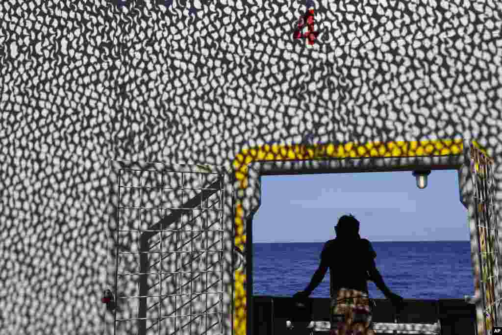 A Norwegian sailor stands on the deck of the Siem Pilot ship during a migrants search and rescue mission in the Mediterranean Sea.