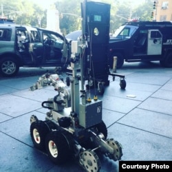 A New York police robot sits on the sidewalk close to a suspect's vehicle in New York City, July 21, 2016.