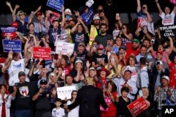 FILE - President Donald Trump greets supporters as he leaves the stage at the end of a rally in Wheeling, W.Va., Sept. 29, 2018.